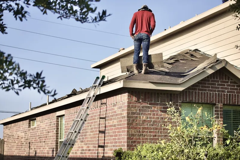 Professional roofer working on a residential roof in Johnson